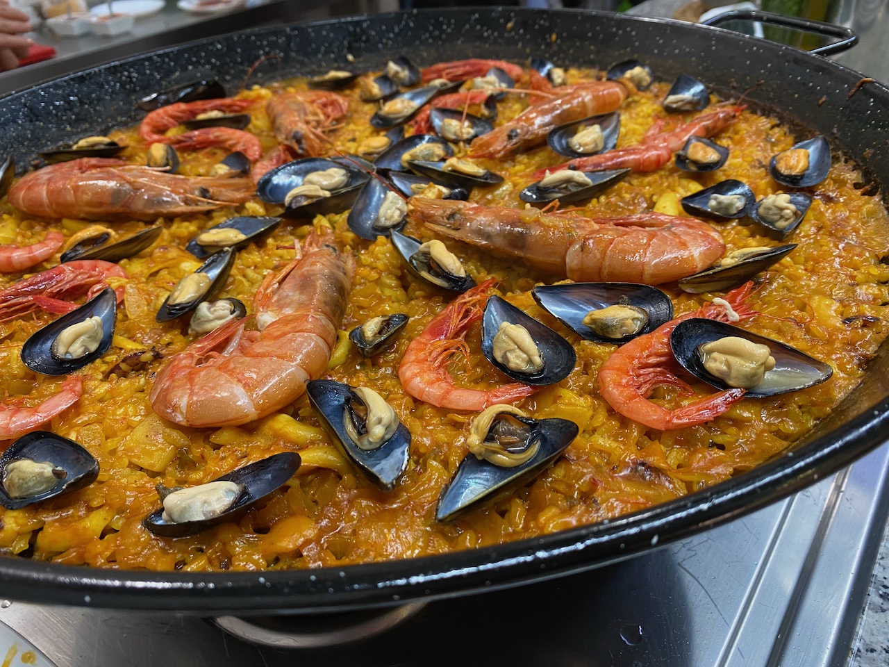 Picture of cooked paella with shrimp and mussels